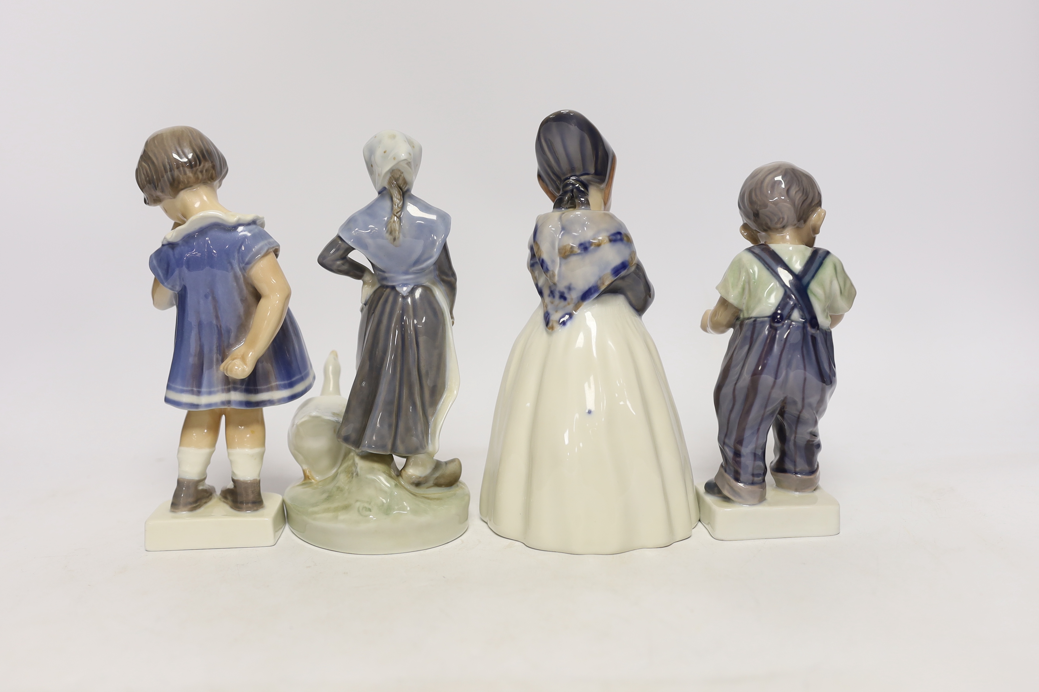 Four Royal Copenhagen figures and figurines of children, largest 19cm high